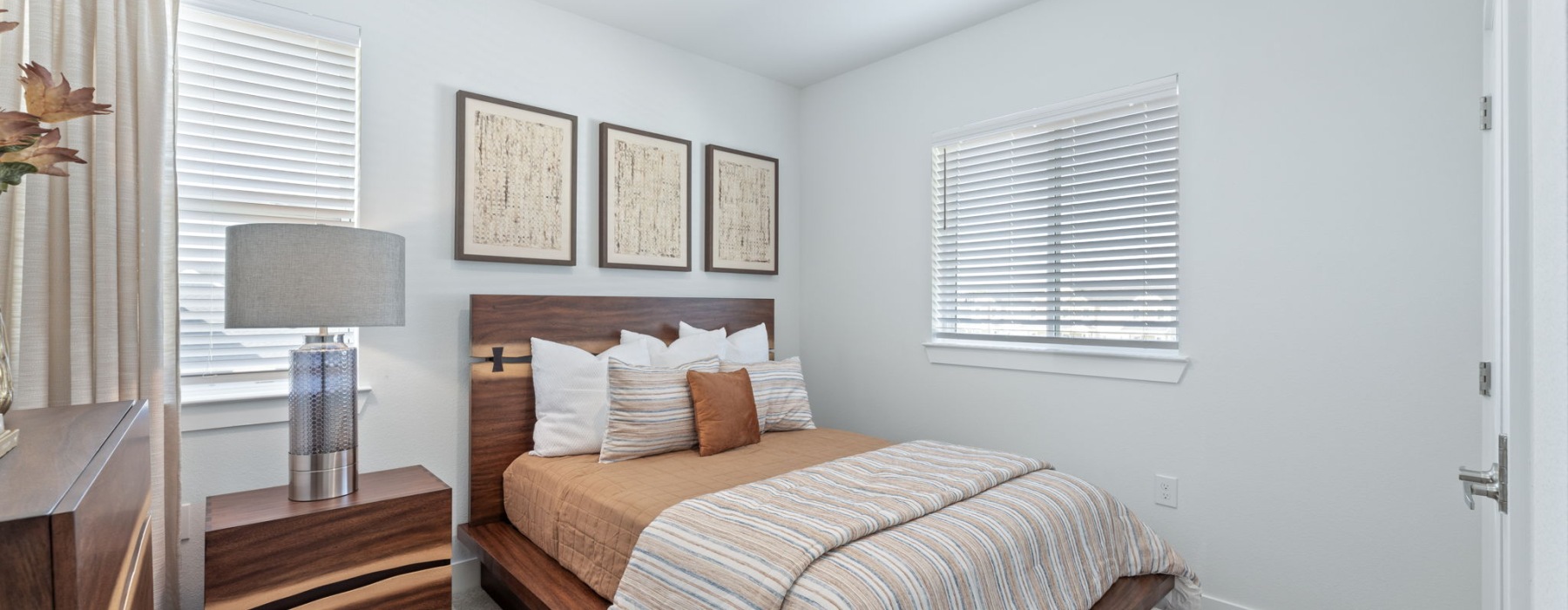 Bedroom with large windows and carpet