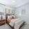 Bedroom with large windows and carpet