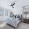 Bedroom with large windows and ceiling fan